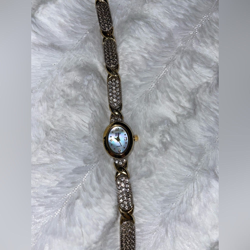 Beautiful gold-tone watch with czs and abalone face.